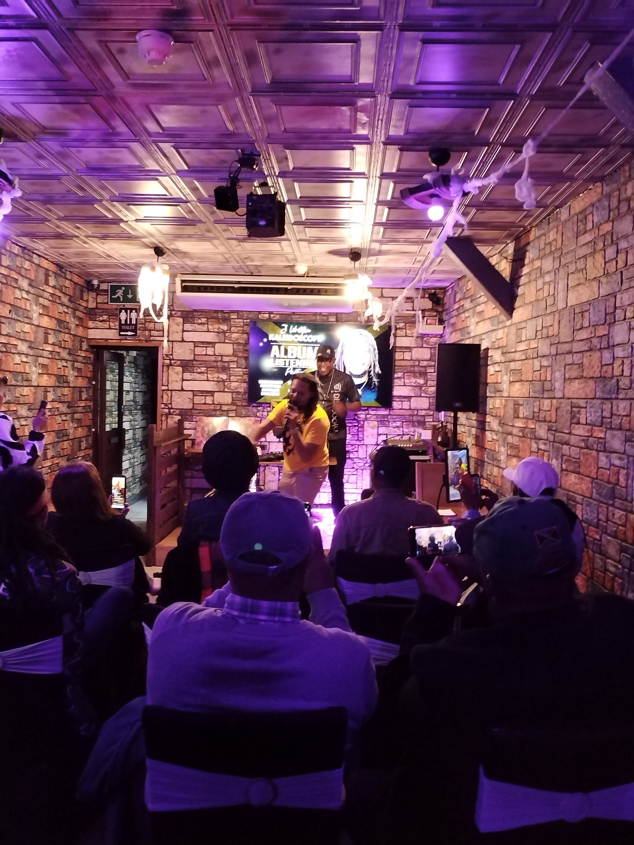 The Marmalade Club main room lit purple with a live act on stage.