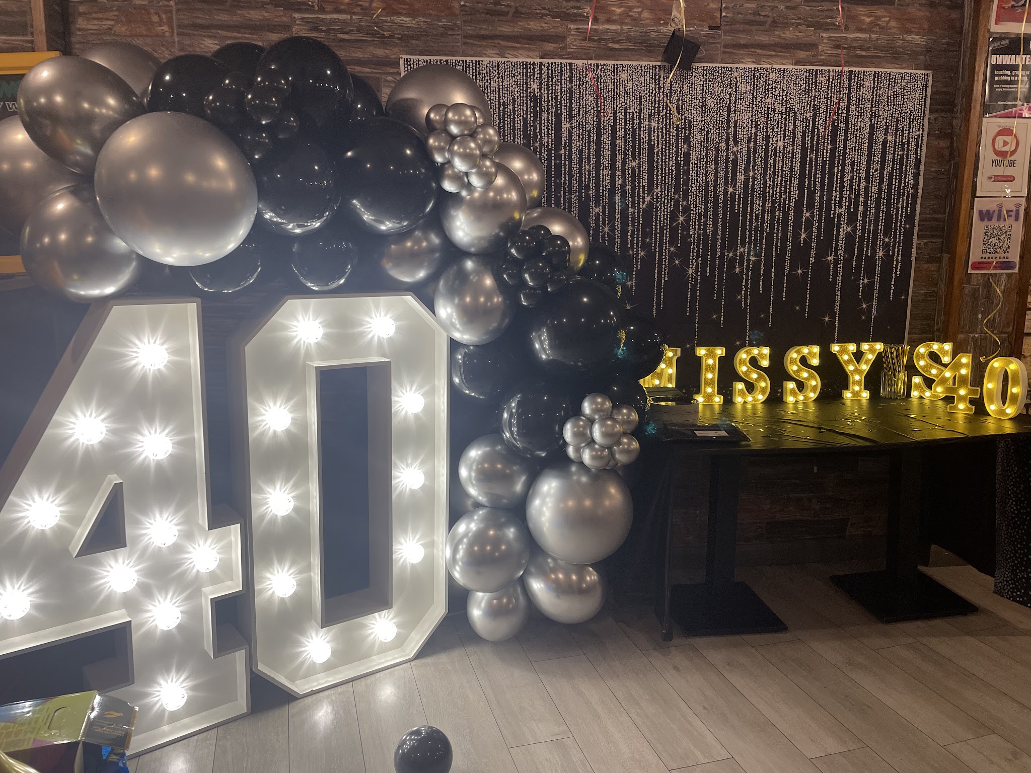 A birthday setup at Marmalade Club with a balloon arch and light-up numbers.